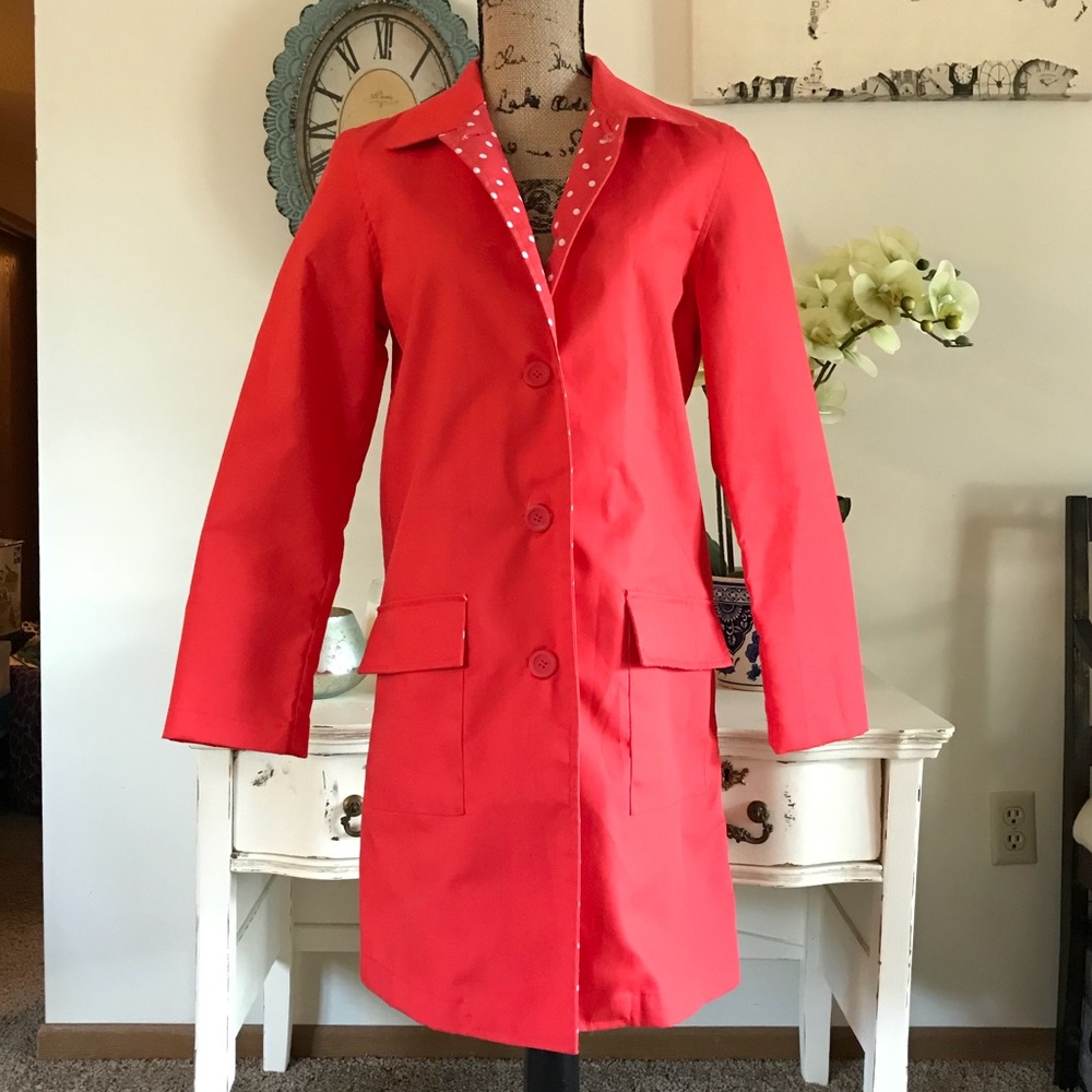 Bright red button-up rain jacket